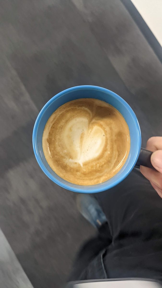 Blue mug from above, with a rounded heart-like shape in tan foam